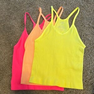Lot of three women’s bright colored tanks. Size M/L (runs really small)